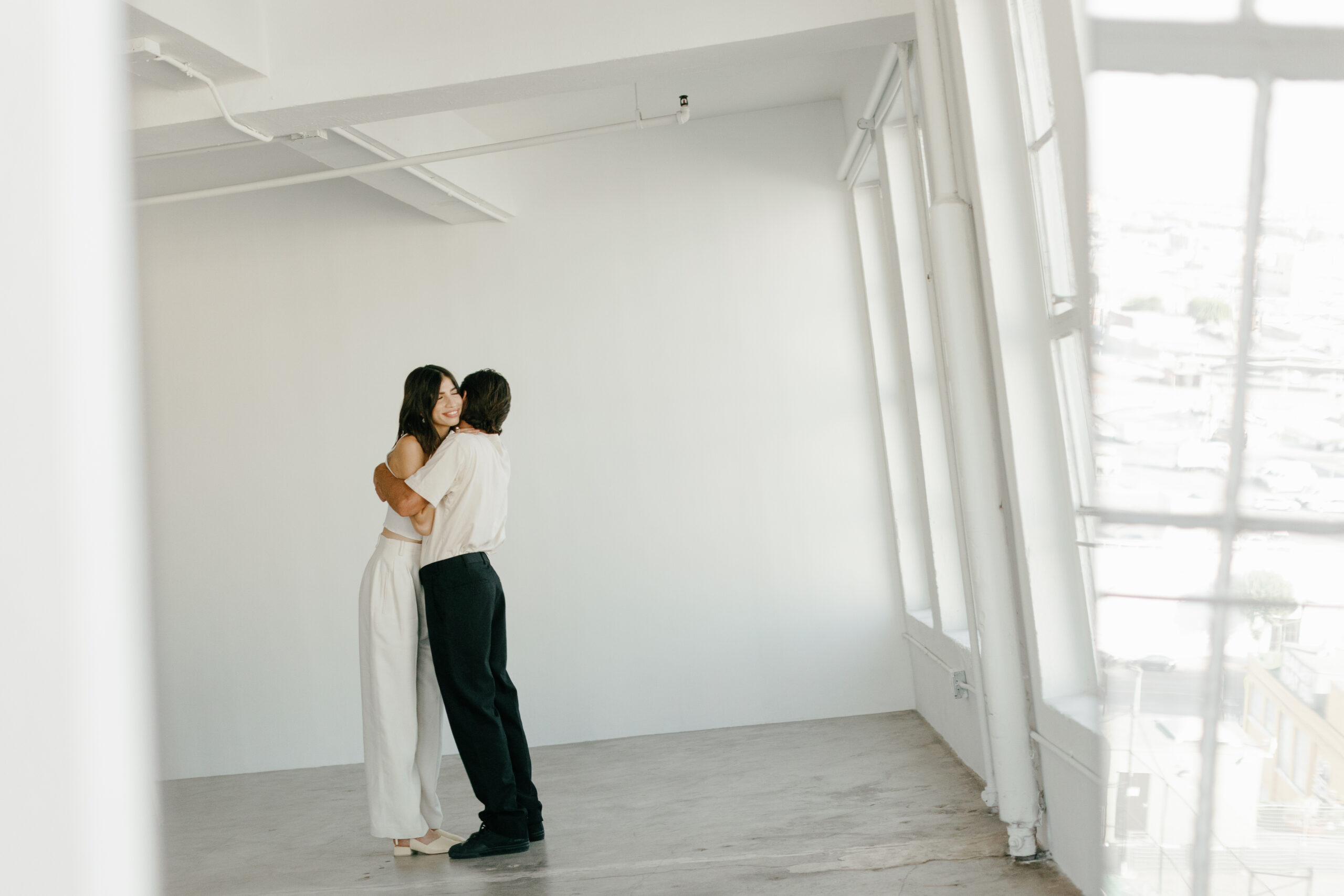 Stylish Couple in Monochromatic Outfits in a Photography Studio