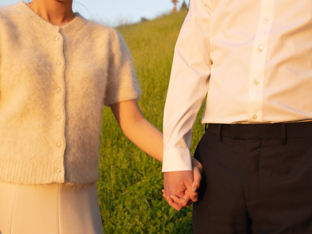 A couple in golden hour holdings hands.