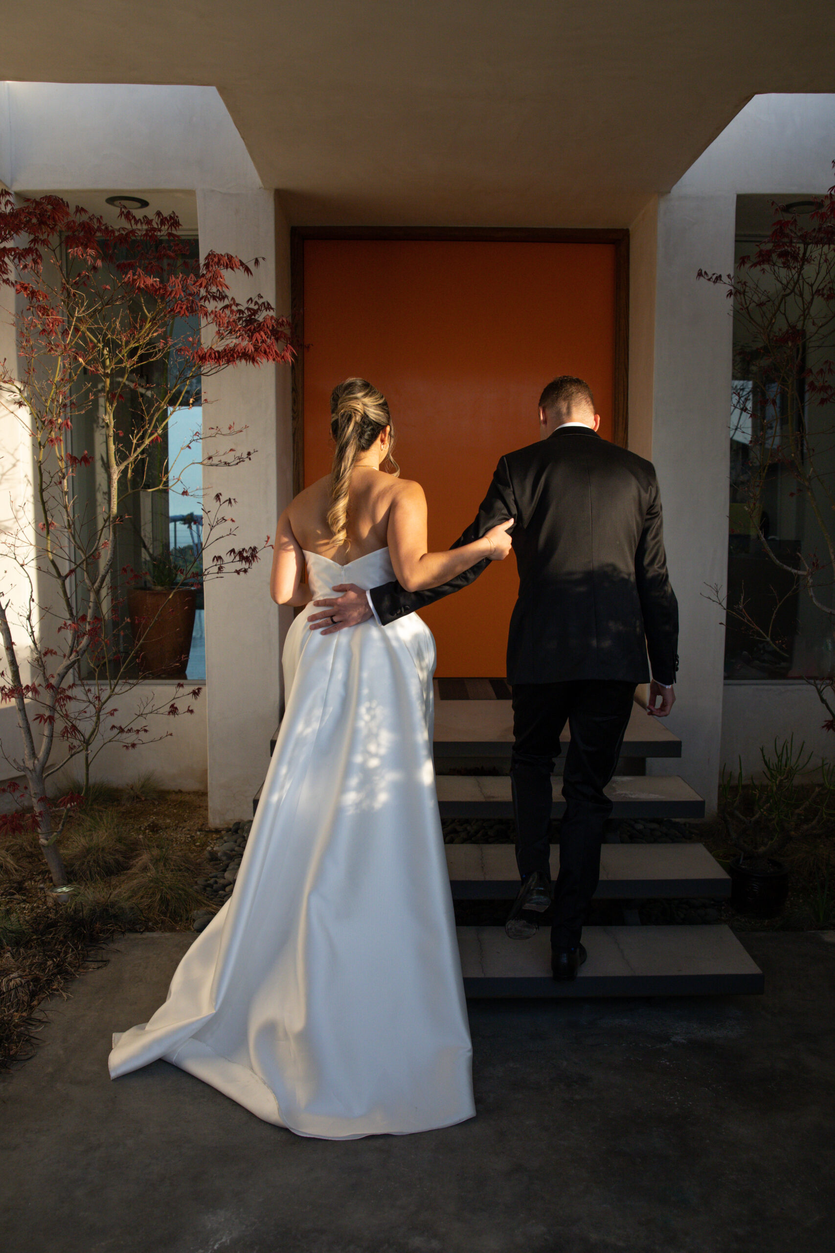 Bride and Groom in front of a private, art deco home.