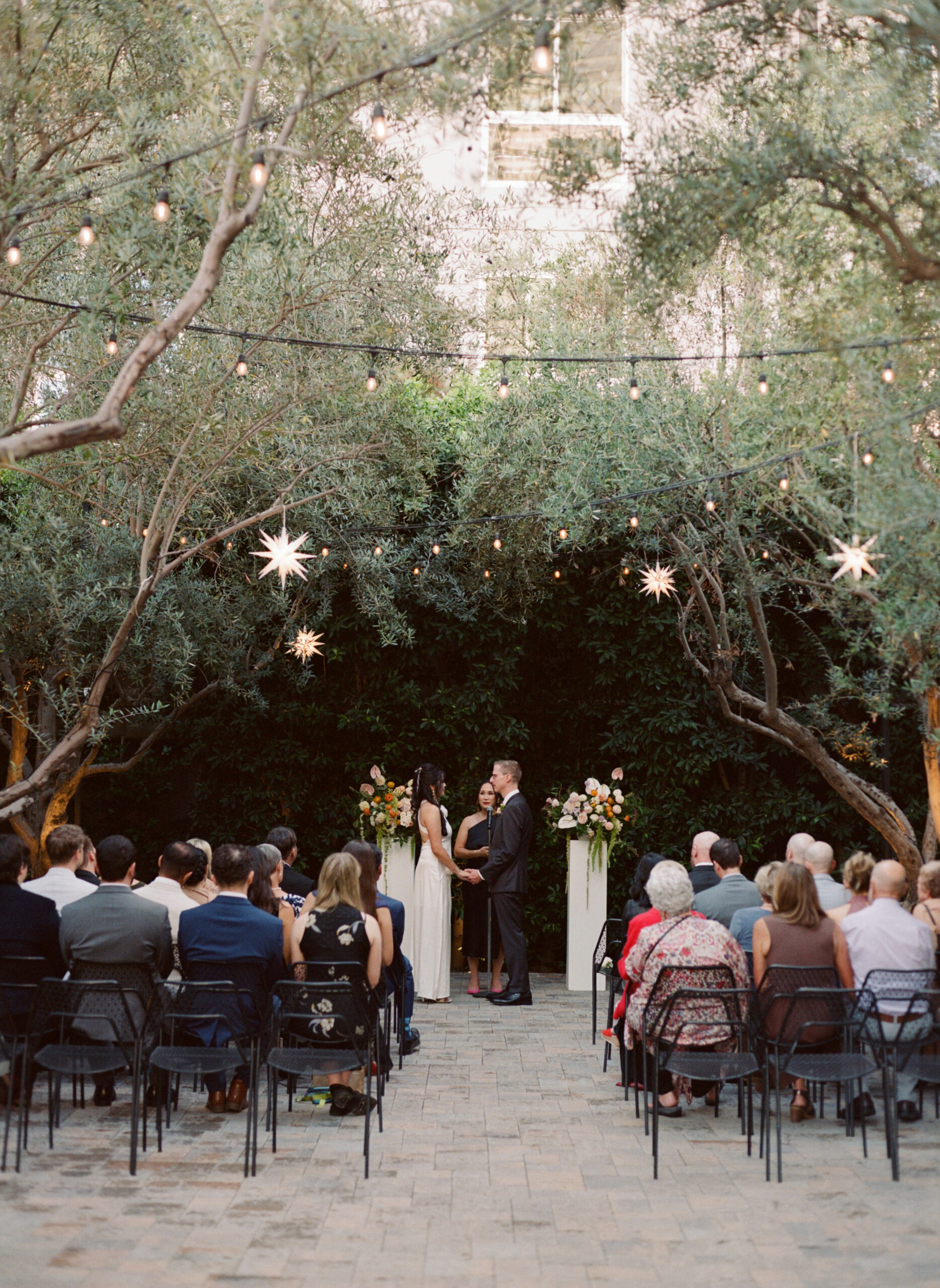 Bride and Groom exchange vows during their wedding ceremony at Redbird in Downtown Los Angeles